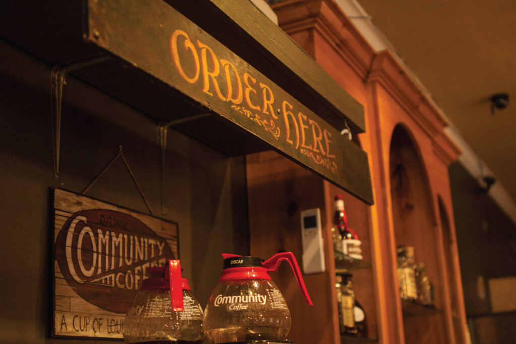 Coffee pots beneath a hand-painted Order Here sign