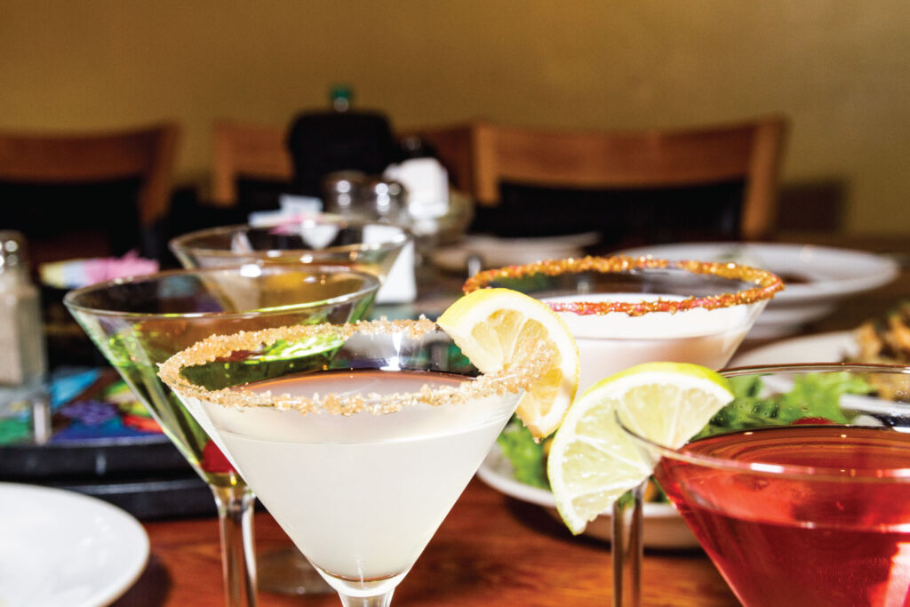 Colorful cocktails garnished with lemon and lime