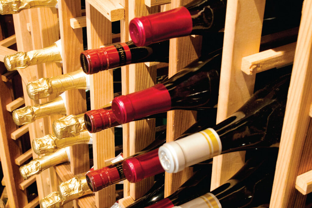 Wine bottles resting in a wooden rack